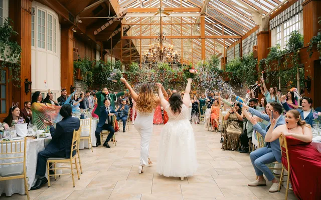 An officiant celebrating with a couple after their ceremony