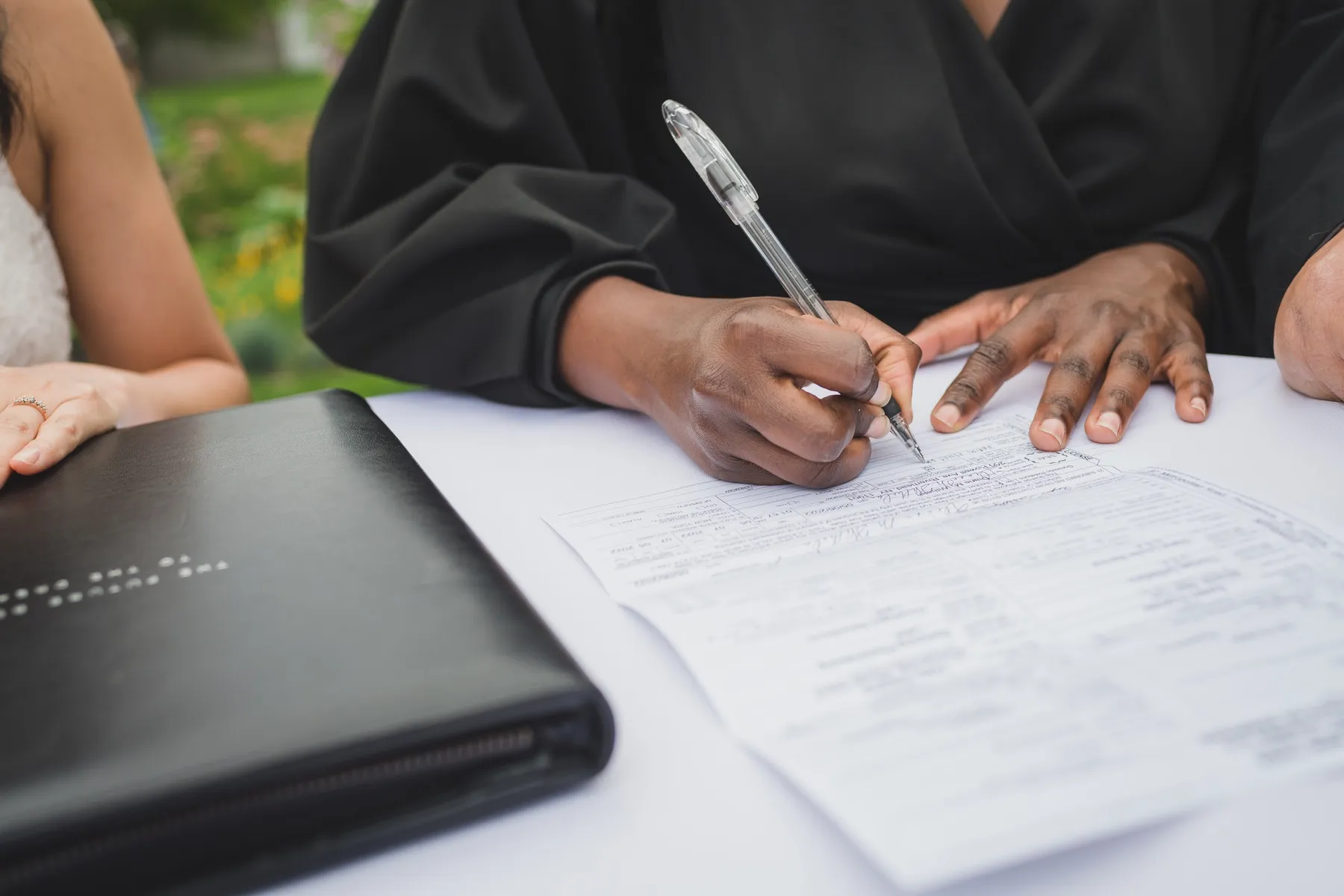 Robyn signing a marriage license